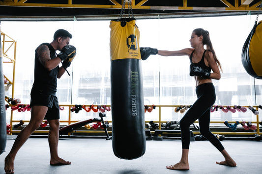 Man and woman engaging in boxing training