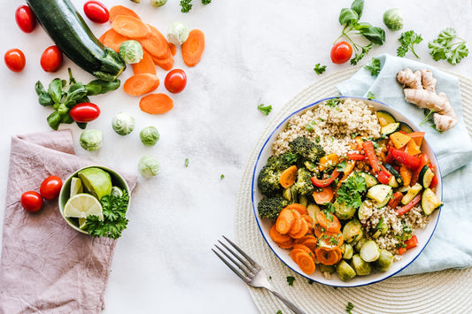 An assortment of colorful and nutritious fruits, vegetables, whole grains, and lean proteins, representing the role of a balanced diet in achieving fitness goals.