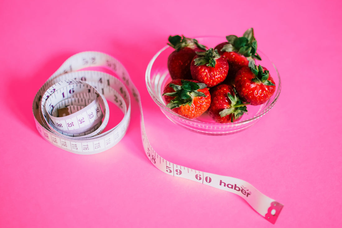  Fresh fruits and vegetables, a measuring tape, and running shoes symbolizing a balanced approach to nutrition and fitness