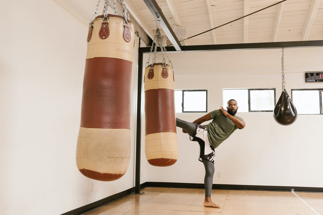 A determined person engaging in kickboxing, illustrating the empowerment and confidence gained through regular exercise.